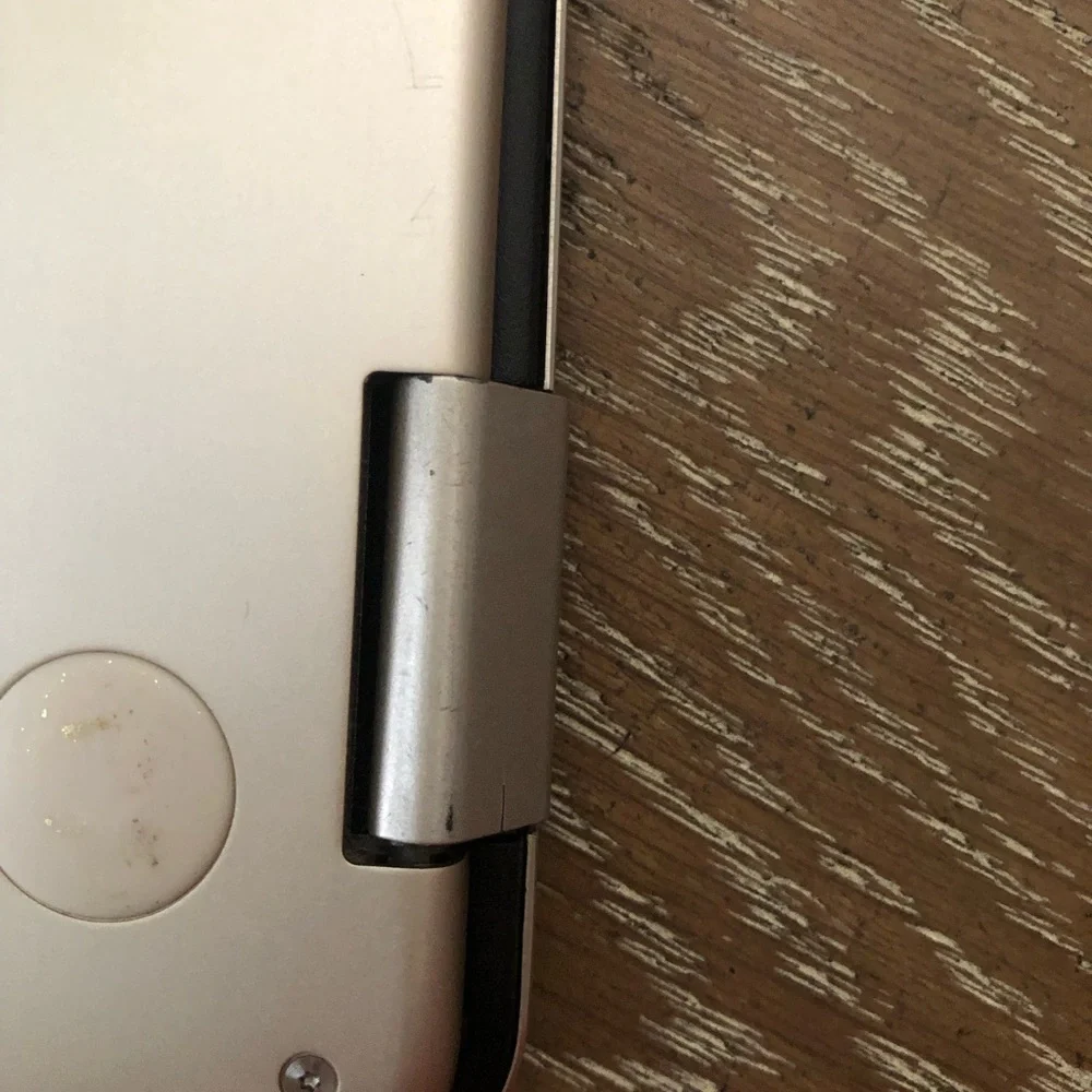 ASUS Metallic Silver Convertible Laptop with a wireless mouse and a charger.